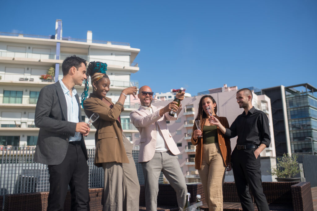 joyful business people on terrace roof party