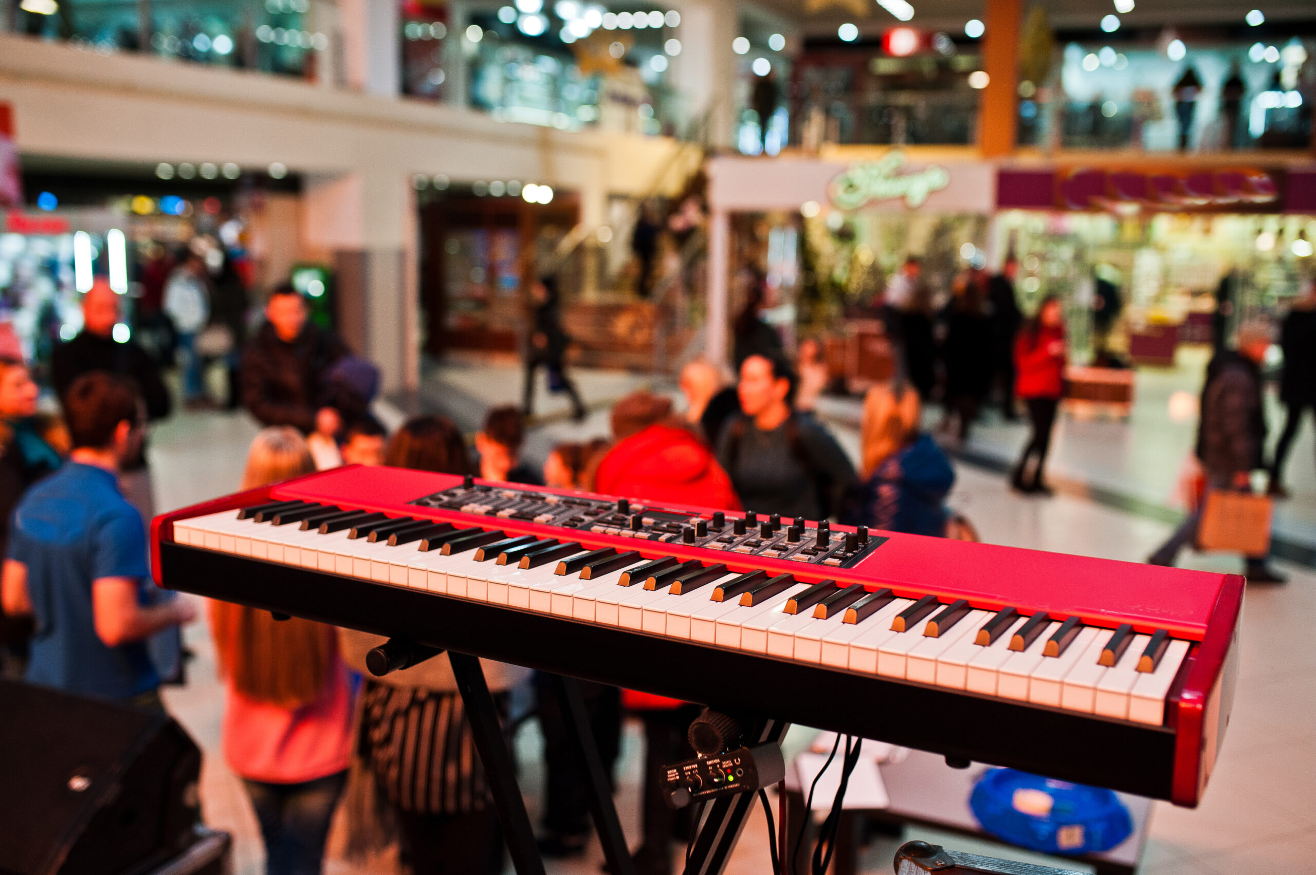 audio piano on stage in a concert hall behing peoples.